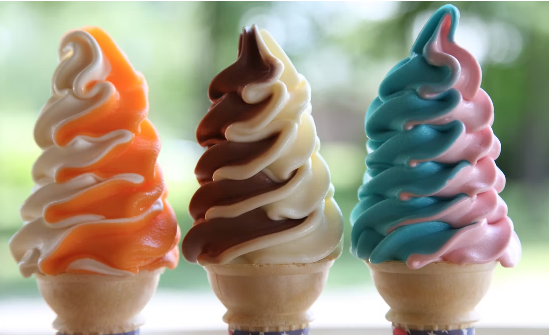 Three swirl soft serve cones — orange sorbet twist, chocolate twist, Smurf and strawberry twist